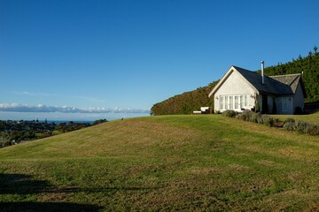 Charming, traditional-style single-family home on a hill in New Zealand.