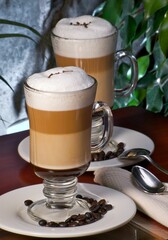 cappuccinos on a table with coffee grains