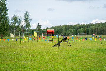 Fototapeta na wymiar Colorful playground for kids with colourful flags in summer camp