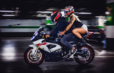 man and a female bikers on sport motorcycle
