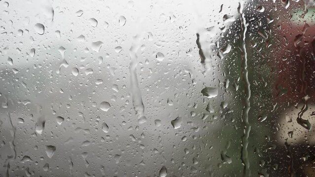Drops of water on the window glass during heavy rain. Rainy season