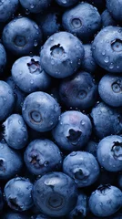Fototapeten Freshly harvested blueberries with water drops, blue fruit wallpaper for phone.  © eshana_blue