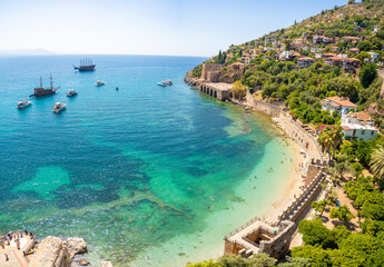 Ancient shipyard or Tersane near of Kizil Kule tower and beautiful beach and calm turquoise sea surface in Alanya, Turkey
