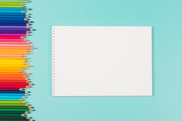 Abstract background for painting, drawing and sketching. Blank white paper spiral notebook and many...
