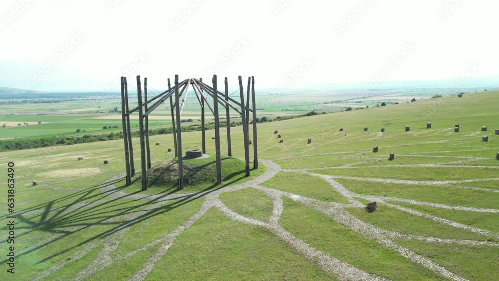 Poster drone shot around big cellar monument with green landscape of hills, hungary