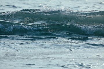 Tranquil ocean scene featuring crystalline waves gently rolling towards the shoreline