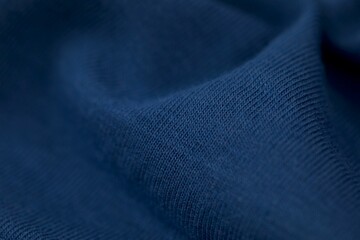 Close-up shot of a piece of light blue fabric with subtle highlights