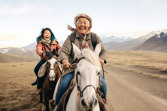 Smiling mature asian woman riding horse in a mountains