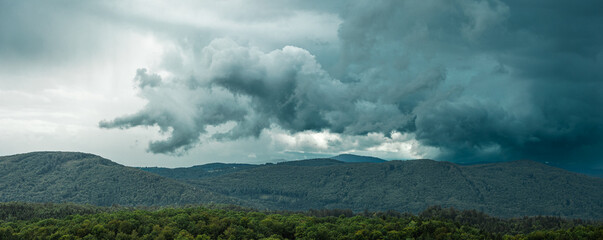 Thick funky storm clouds above slovenia in shape of a chinese dragon or dog on a leash. Dangerous...