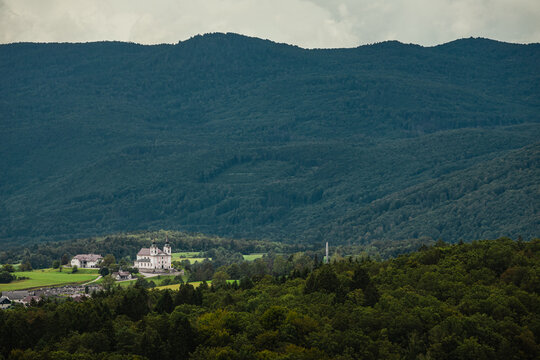 Church in zuzemberk viewed from far, from reber plateau with other hills visible in the background
