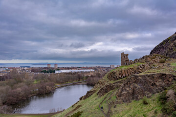 Fototapeta na wymiar Fantastic view from up hill towards Edinburgh city and Holyrood Park on a cloudy spring day