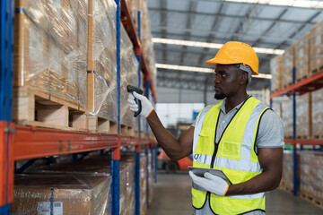 African American male warehouse worker scanning barcodes on boxes on shelf pallet in the storage warehouse. Man worker working in the warehouse