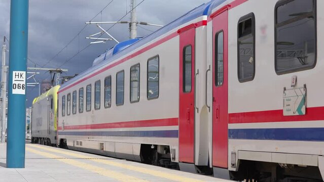 4K footage of slowly departing mainline passenger train from station.