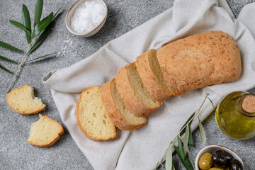 Ciabatta bread sliced olives and olive oil, top view