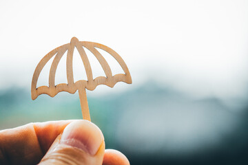 Man holding an umbrella symbol, rainy day, Concept for insurance, policies, family life insurance,...