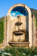 An idyllic stone fountain in the medieval town of Chiavenna, Italy