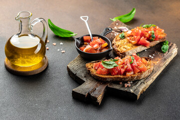 Fresh italian sandwiches with tomatoes on wooden board. Delicious snack and appetizer. place for text, top view