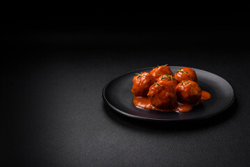 Delicious fresh meatballs in tomato sauce with salt, spices and herbs