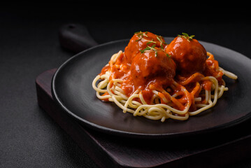 Delicious fresh meatballs and pasta in tomato sauce with salt, spices and herbs