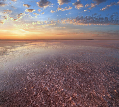 Sunset on the Genichesk pink extremely salty lake (colored by microalgae with crystalline salt depositions), Ukraine.