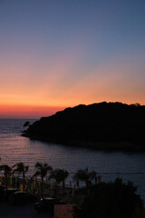 An island in the bay of Ksamil Albania by sunset.