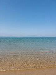 Fototapeta na wymiar A blue beach with blue sky and a small island in the back in Enez Edirne