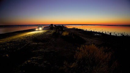 Charming evening photo with car light on the Kuyalnik salt estuary. Dead lake near Odessa Ukraine. © Alex