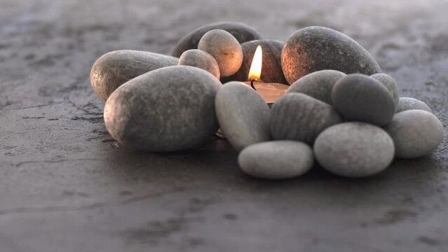 Pebble stones with tea-candle and smoke for meditation and relax atmosphere 