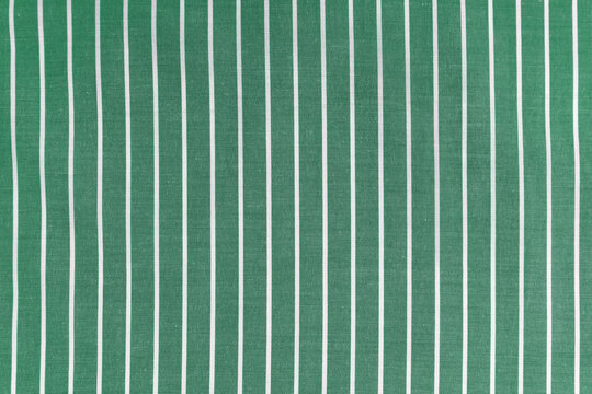 Fototapeta Striped green white fabric texture background wtih copy space. Shirt fabric, tablecloth textile, garment cloth, upholstery with classic pattern with lines. Backdrop, wallpaper, background.