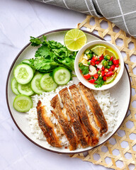Fried fish rice with chili fish sauce With cucumber, coriander,lemon , top view on the marble background , Thai style street food