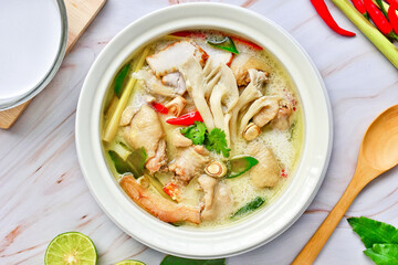 Tom kha kai ,chicken in coconut milk soup on white bowl ,top view ,It is Thai food, curry with coconut milk.