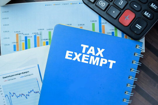 Concept of Tax Exempt write on book isolated on Wooden Table.