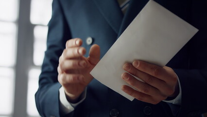 Businessman taking euro envelope indoors close up. Manager received bribe.