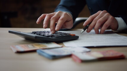 Man hands counting calculator sitting table close up. Accountant calculating.