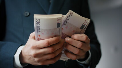 Man hands counting banknotes indoors closeup. Businessman calculating pack bills