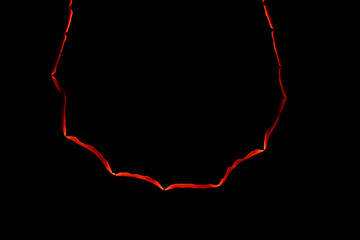 burning paper, glowing edge of paper on a black background