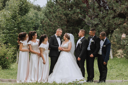 A beautiful couple at a wedding with friends in a beautiful location, staged photo