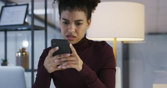 Phone, typing and confused woman in office with spam, fake news or email at night. Cellphone, confusion and African female person with glitch, error or problem, scam or website, app or online at work