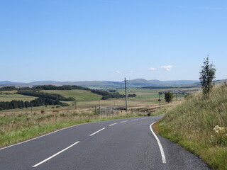 Fototapeta premium Road cutting through the countryside