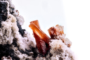 orange red topaz crystal on white background. macro detail texture background. close-up raw rough...