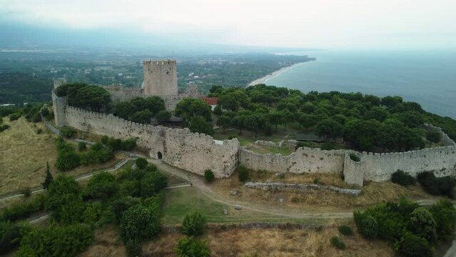 Aerial ascending with tilt motion view of Platamon castle in Greece. Drone view of the Platamon Castle is a Crusader castle in Macedonia, Greece and is located southeast of Mount Olympus