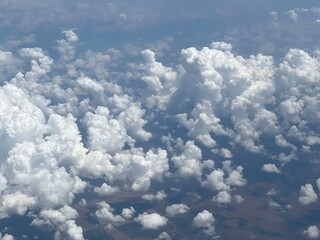 Aerial view looking down on small, puffy clouds above Eden, Texas