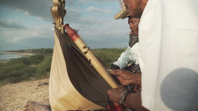 Close up of man's hands plucking Sasando, Traditional String Music
