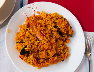 Plate of tasty seafood paella with rice, mussels and shrimps, nobody