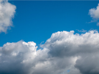 White single clouds over blue sky background. Fluffy cumulus clouds shape