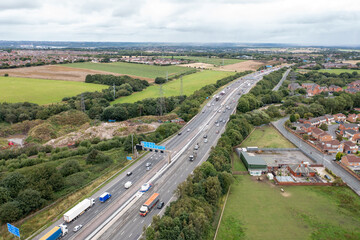 Fototapeta na wymiar Aerial photo of the village of East Ardsley in the City of Leeds metropolitan borough, in West Yorkshire, England showing a typical British housing estate along side a busy motorway highway