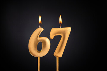 Birthday candle number 67 - Birthday celebration on black background