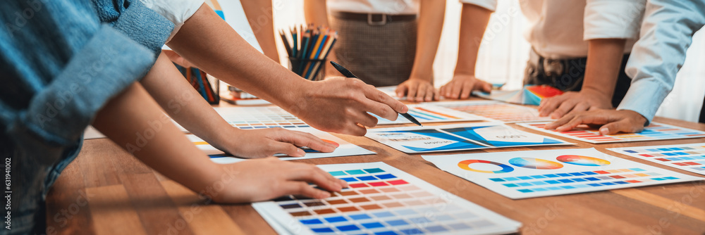 Aufkleber Graphic designer brainstorm logo and graphic art at busy creative studio workshop. Experiment and brainstorm color palette and pattern at workspace table for creative design. Panorama shot. Scrutinize