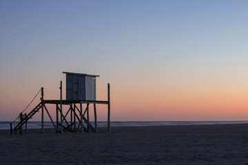 Fototapeta na wymiar Lifeguard box on a serene sunrise