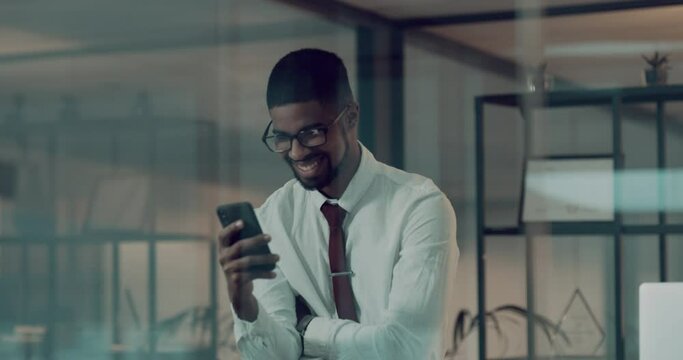 Night, business and black man with a smartphone, achievement and happiness in a modern office. Male person, happy employee and agent with success, cellphone and celebration with connection and winner